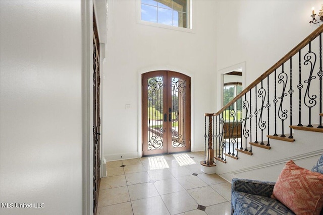 12025 Springridge Rd, Terry, MS 39170 - foyer entrance featuring french doors, a towering ceiling, arched walkways, stairway, and light tile patterned floors