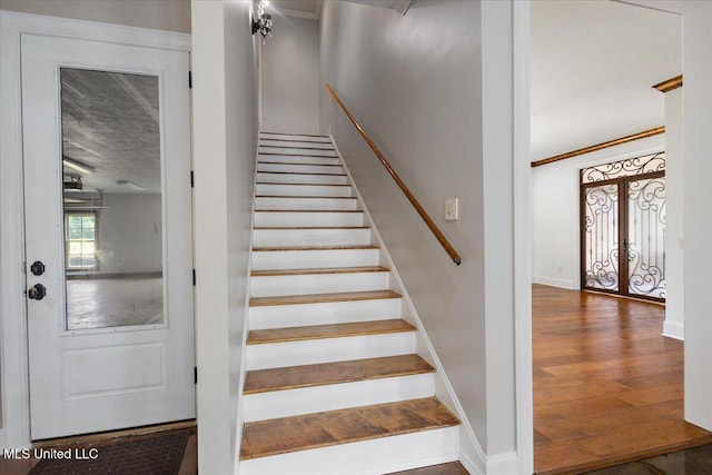 12025 Springridge Rd, Terry, MS 39170 - staircase featuring wood finished floors, ornamental molding, and french doors