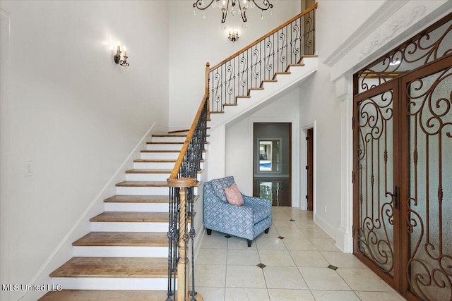 12025 Springridge Rd, Terry, MS 39170 - tiled foyer entrance featuring a towering ceiling, stairs, a chandelier, and french doors
