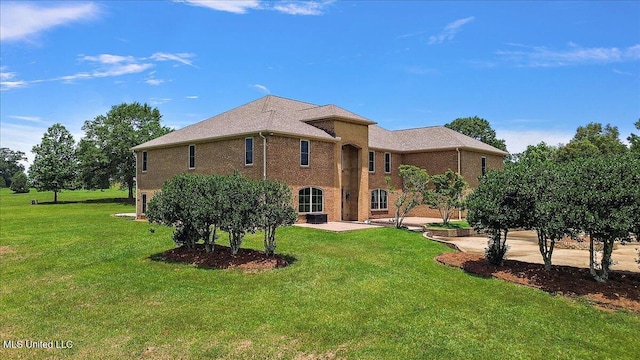 12025 Springridge Rd, Terry, MS 39170 - back of house featuring a lawn, a patio, and brick siding