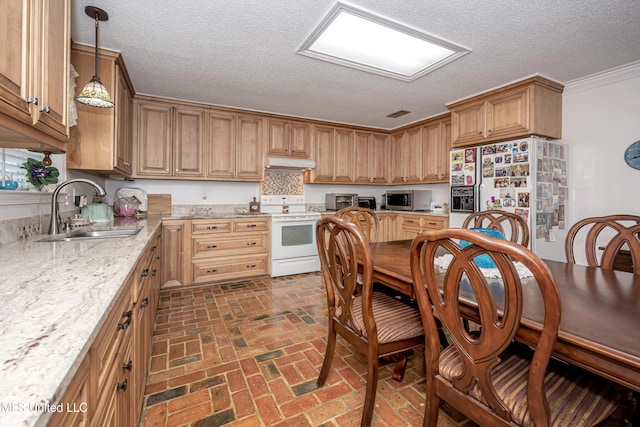 10001 Echo Glen Dr, Moss Point, MS 39562 - kitchen with white appliances, under cabinet range hood, brick flooring, a textured ceiling, and light stone countertops