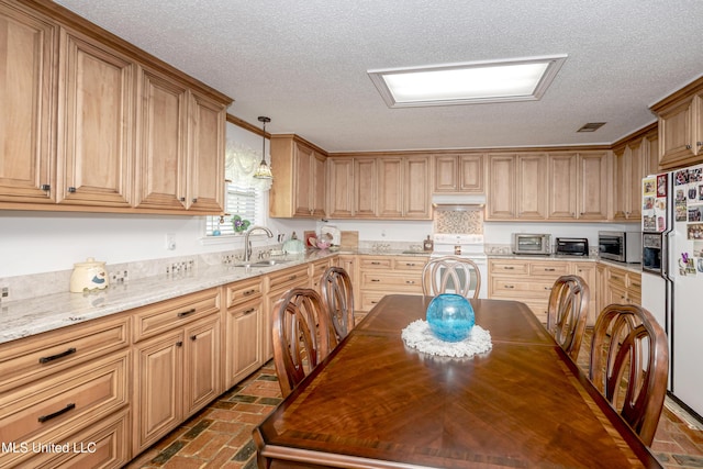 10001 Echo Glen Dr, Moss Point, MS 39562 - kitchen with white appliances, under cabinet range hood, brick flooring, a textured ceiling, and light stone countertops