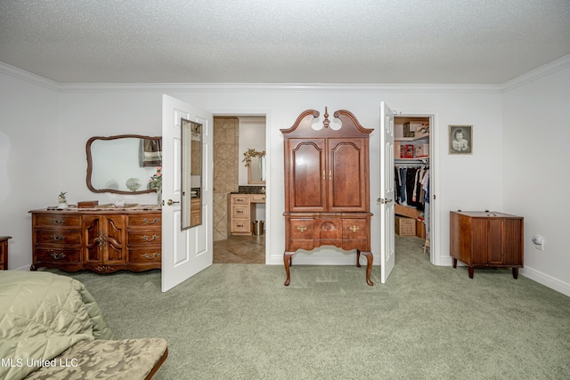 10001 Echo Glen Dr, Moss Point, MS 39562 - bedroom featuring crown molding, light colored carpet, a walk in closet, a textured ceiling, and ensuite bath