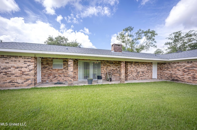 10001 Echo Glen Dr, Moss Point, MS 39562 - back of property featuring a lawn, a chimney, brick siding, and a patio area