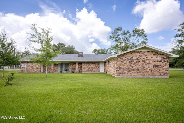10001 Echo Glen Dr, Moss Point, MS 39562 - rear view of property with a yard, brick siding, and a chimney