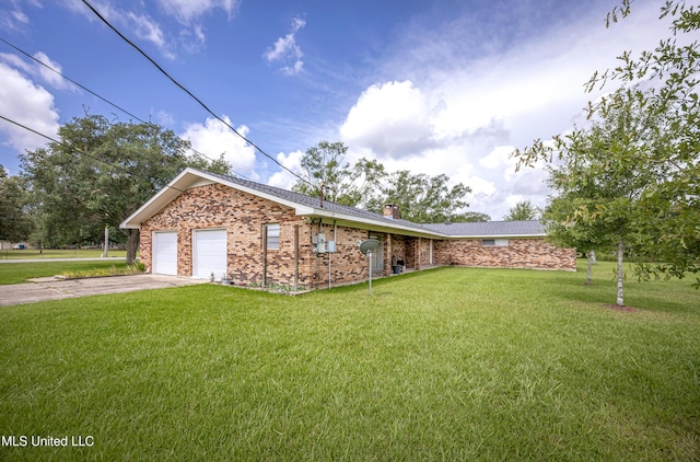 10001 Echo Glen Dr, Moss Point, MS 39562 - view of front of property with a front yard, a chimney, driveway, brick siding, and a garage