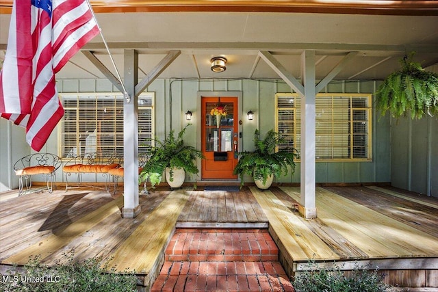 entrance to property with covered porch and board and batten siding