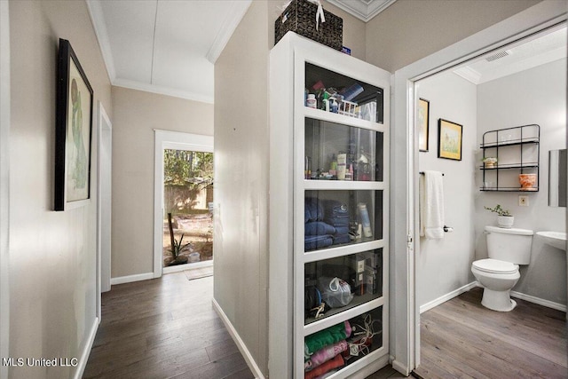 hall with crown molding and hardwood / wood-style flooring