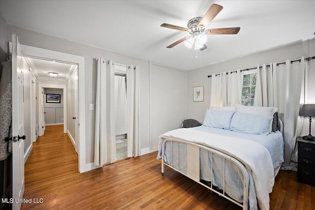 bedroom with ceiling fan, baseboards, and wood finished floors