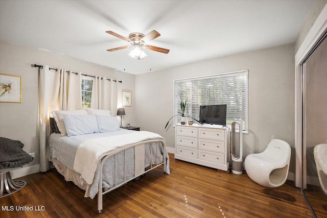 bedroom with a closet, dark wood-type flooring, and ceiling fan