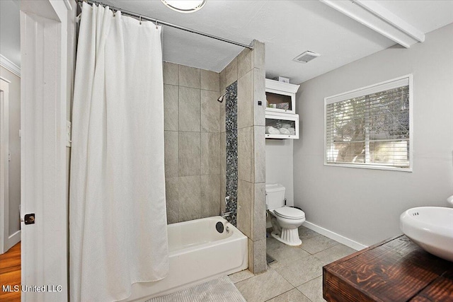 bathroom featuring toilet, baseboards, visible vents, tile patterned flooring, and shower / bathtub combination with curtain
