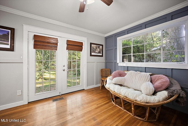 sitting room featuring crown molding, light hardwood / wood-style flooring, french doors, and ceiling fan