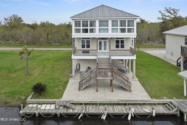 back of property featuring french doors, a patio area, and a lawn