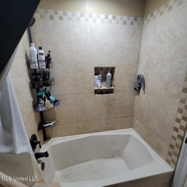 bathroom with bathing tub / shower combination