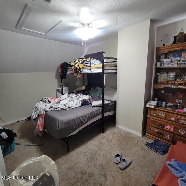 bedroom with a textured ceiling, light colored carpet, and ceiling fan