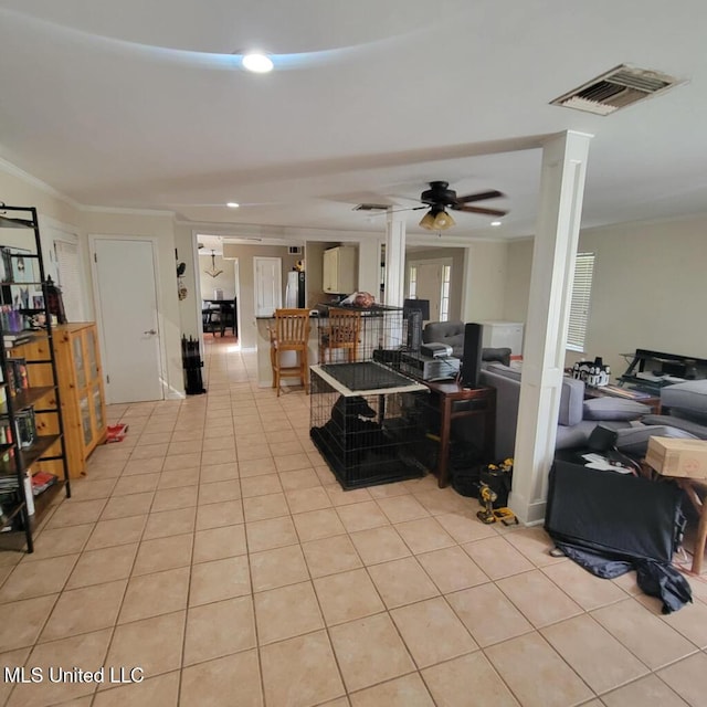 living room with ceiling fan, light tile patterned floors, and crown molding