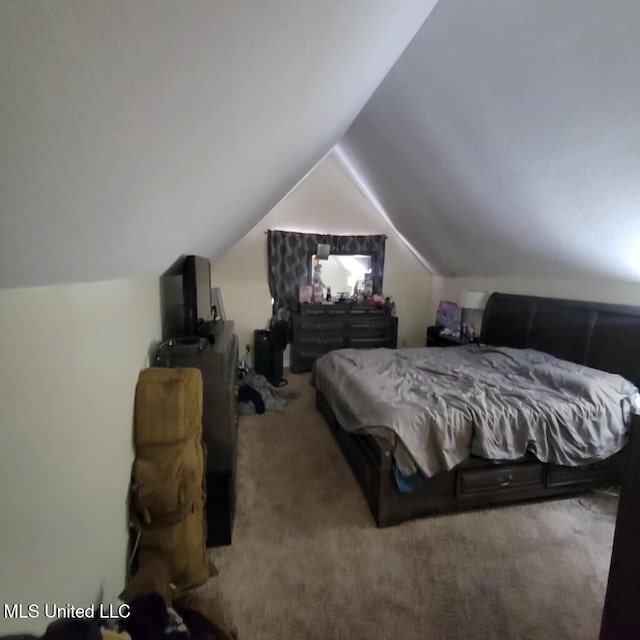 carpeted bedroom with lofted ceiling