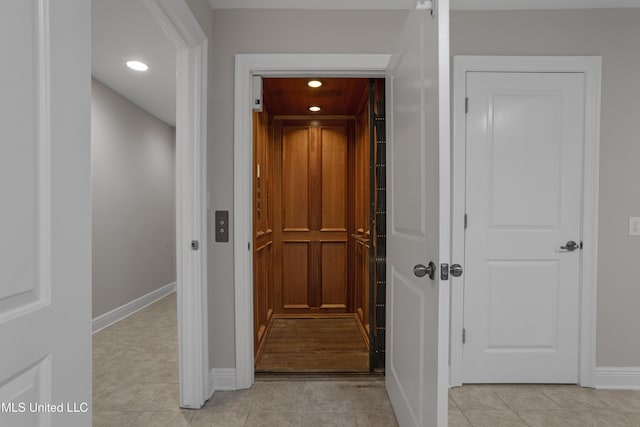 80 E Beach St Unit 4, Gulfport, MS 39507 - corridor featuring elevator, light tile patterned floors, baseboards, and recessed lighting