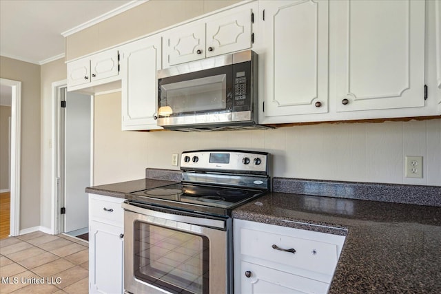 310 Lafayette St, Senatobia, MS 38668 - kitchen featuring white cabinets, light tile patterned floors, stainless steel appliances, and crown molding