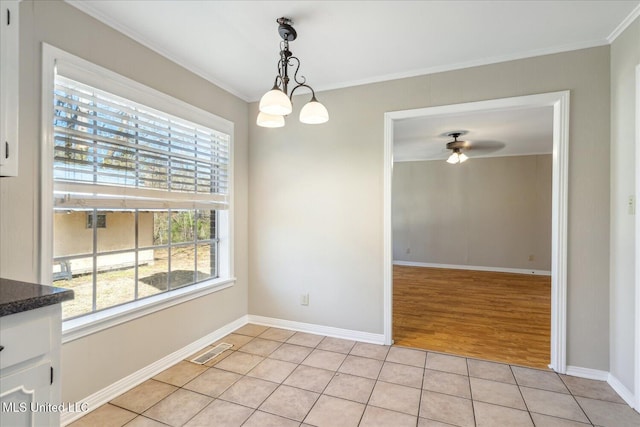 310 Lafayette St, Senatobia, MS 38668 - unfurnished dining area with light tile patterned flooring, ceiling fan with notable chandelier, visible vents, baseboards, and crown molding