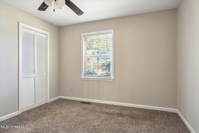 310 Lafayette St, Senatobia, MS 38668 - unfurnished bedroom featuring baseboards, visible vents, ceiling fan, carpet flooring, and a closet