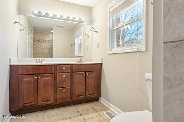 310 Lafayette St, Senatobia, MS 38668 - bathroom with double vanity, visible vents, toilet, tile patterned floors, and a sink