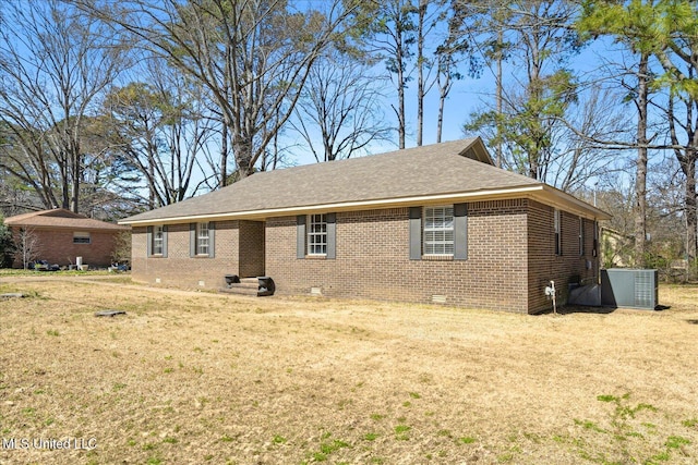 310 Lafayette St, Senatobia, MS 38668 - exterior space with roof with shingles, crawl space, a yard, central air condition unit, and brick siding