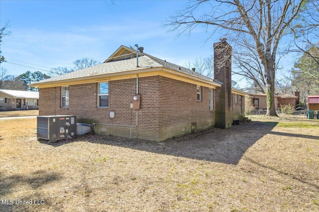 310 Lafayette St, Senatobia, MS 38668 - view of side of property with central AC, brick siding, a chimney, and crawl space