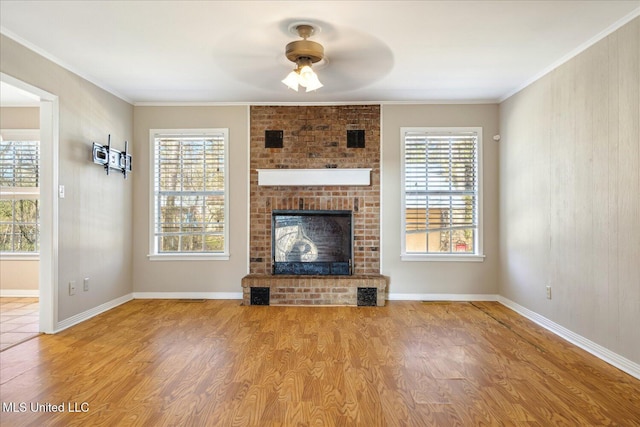 310 Lafayette St, Senatobia, MS 38668 - unfurnished living room with crown molding, a fireplace, baseboards, and wood finished floors