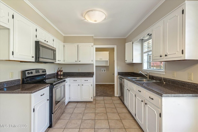 310 Lafayette St, Senatobia, MS 38668 - kitchen featuring dark countertops, white cabinetry, appliances with stainless steel finishes, and a sink