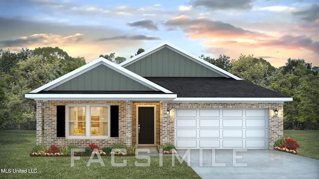 view of front of house with a yard and a garage