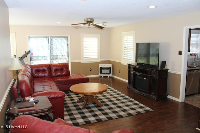 living area with recessed lighting, wood finished floors, ceiling fan, and heating unit