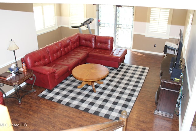 living area with wood finished floors and baseboards