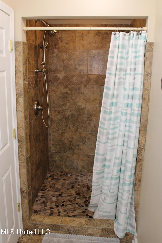 full bath featuring a shower stall