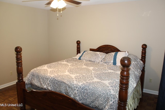 bedroom featuring baseboards and ceiling fan