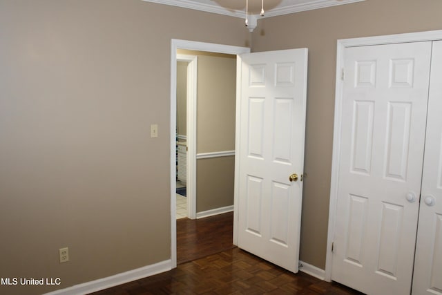 unfurnished bedroom featuring baseboards and ornamental molding