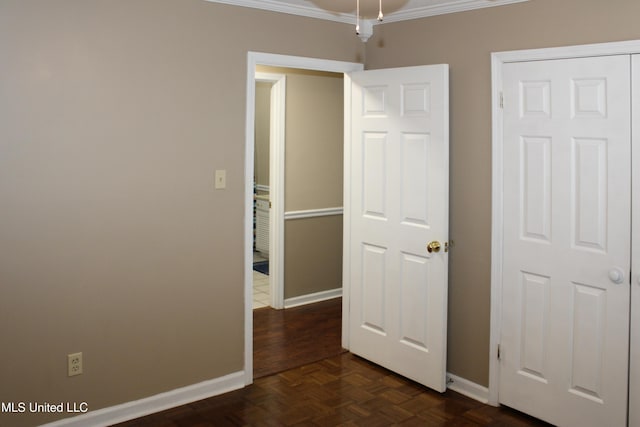 unfurnished bedroom with baseboards and crown molding
