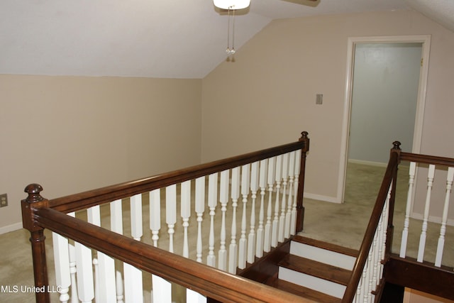 staircase with carpet, lofted ceiling, and baseboards