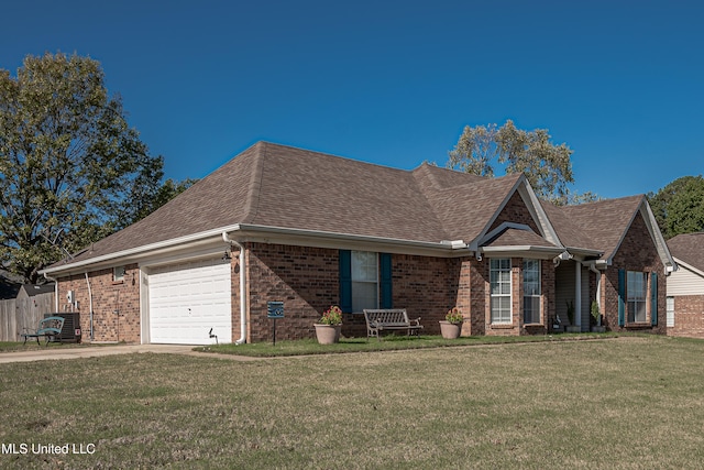 view of front of property featuring central AC unit, a garage, and a front lawn