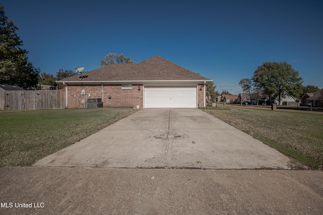 view of front of property with a front yard and a garage