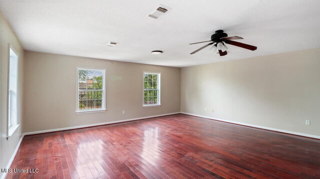 empty room with ceiling fan and hardwood / wood-style floors