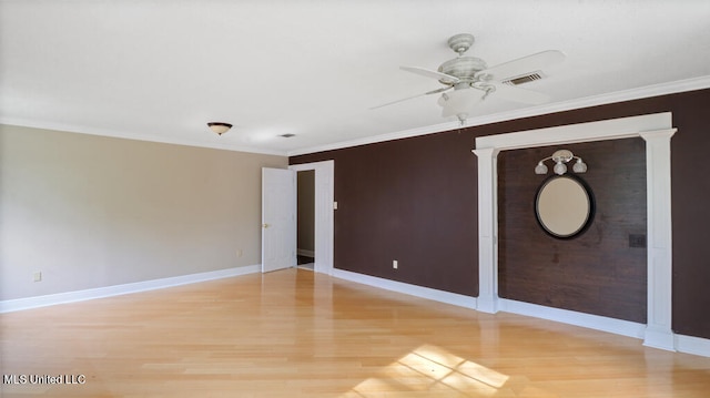 spare room featuring crown molding, ceiling fan, and light hardwood / wood-style flooring