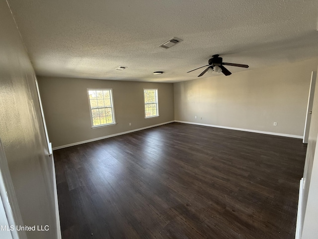 unfurnished room featuring ceiling fan, dark wood finished floors, a textured ceiling, and visible vents