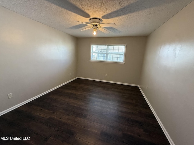 unfurnished room featuring baseboards, a ceiling fan, a textured ceiling, and dark wood-style floors