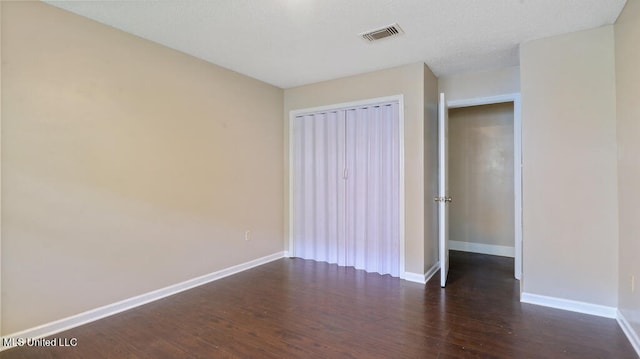 spare room with dark hardwood / wood-style floors