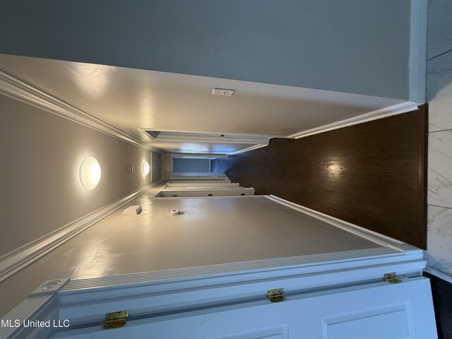 hallway featuring crown molding