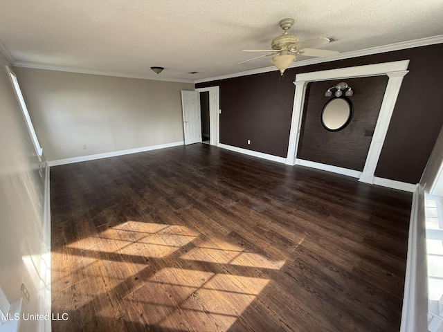 unfurnished room featuring ornamental molding, ceiling fan, a textured ceiling, and dark hardwood / wood-style flooring