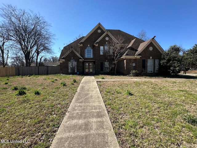 400 Argonne Ave, Shelby, MS 38774 - traditional-style home with brick siding, fence, french doors, and a front yard