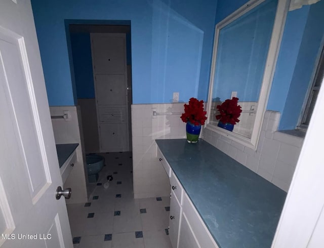 4805 Washington Ave, Gulfport, MS 39507 - bathroom with vanity, tile patterned flooring, tile walls, and wainscoting
