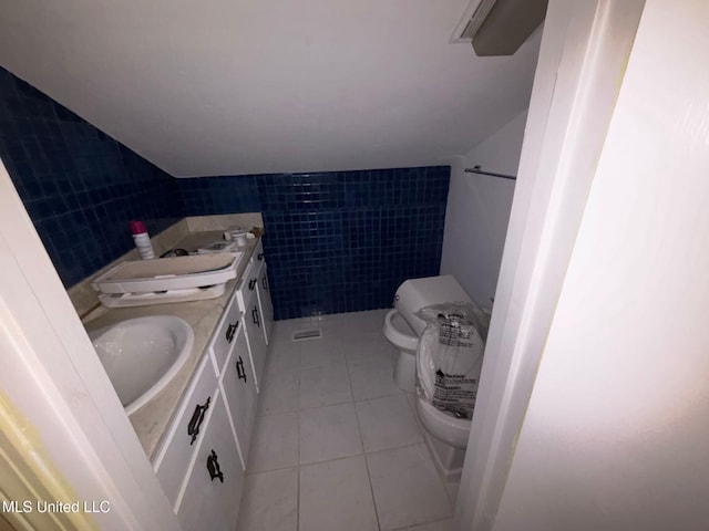 4805 Washington Ave, Gulfport, MS 39507 - bathroom featuring tile patterned floors, double vanity, and tile walls